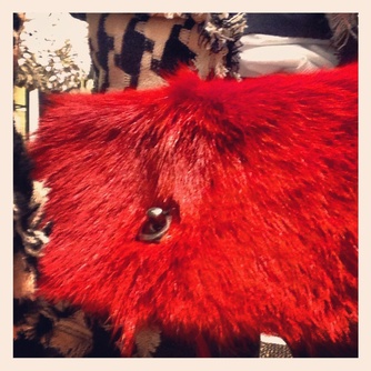 Texture and color, like the bright red fur on this Chanel bag, allow designers to present essentials as “ever new.”