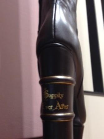 The heel of this knee-high black boot says “Happily Ever After.” Its mate’s heel reads “Once Upon a Time.”