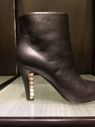 The classic Chanel pearl details have migrated to the heel of this boot.