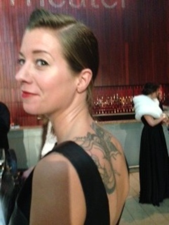 Tatted Lagerfeld event reveler in foreground, white stole in background. Stylistic mashup